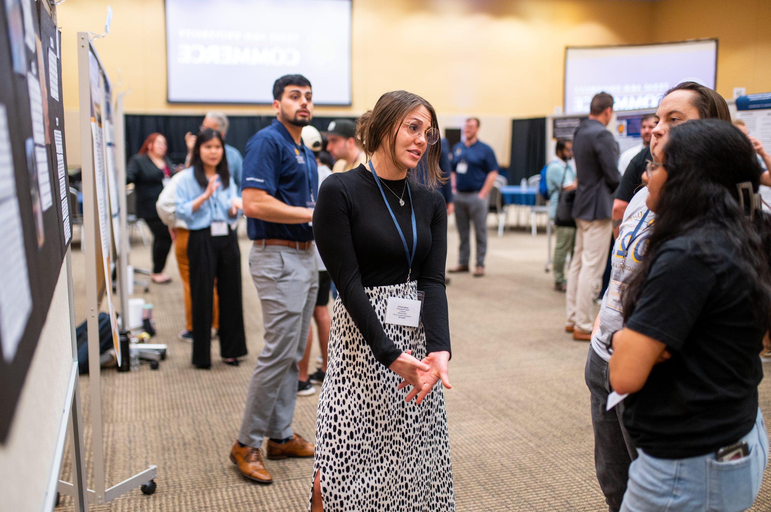 A female student speaking with potential new students.