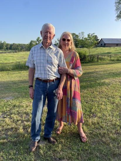 Couple stands in the countryside